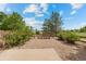 Scenic view of the backyard featuring a patio, gravel, and trees at 101 Granby Way # B, Aurora, CO 80011