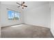 Spacious bedroom featuring a ceiling fan, bright windows, plush carpet, and vaulted ceiling at 101 Granby Way # B, Aurora, CO 80011