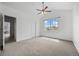 Large bedroom with plush carpeting, bright windows, a ceiling fan, and white walls at 101 Granby Way # B, Aurora, CO 80011