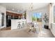 Dining area with a modern light fixture and sliding glass door; kitchen is visible at 101 Granby Way # B, Aurora, CO 80011