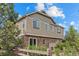 Back exterior elevation of the home with stone and siding and a fenced yard at 101 Granby Way # B, Aurora, CO 80011