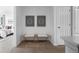 Inviting hallway featuring decor art, a cushioned bench, and white doors at 101 Granby Way # B, Aurora, CO 80011