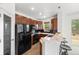 Kitchen with dark wood cabinets and bar seating offering seamless dining room integration at 101 Granby Way # B, Aurora, CO 80011