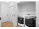 Bright laundry room with side-by-side washer and dryer and storage space at 101 Granby Way # B, Aurora, CO 80011
