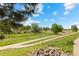 Scenic view of the community trail with lush green trees and landscaping at 101 Granby Way # B, Aurora, CO 80011