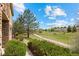 View of the community trail with mature trees and manicured landscaping at 101 Granby Way # B, Aurora, CO 80011
