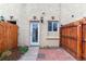 A charming backyard features brick paving, a white exterior door, and decorative lights at 1804 Grove St, Denver, CO 80204