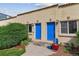 Charming townhouse exterior with blue doors, terracotta roof, and landscaped entryway at 1804 Grove St, Denver, CO 80204