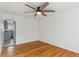 Bright living room leading to kitchen area, with hardwood floors and a ceiling fan at 1804 Grove St, Denver, CO 80204