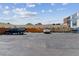 Exterior image shows a large, paved parking lot surrounded by fencing and vehicles at 1804 Grove St, Denver, CO 80204