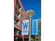 Street sign reading 'Colfax Neighborhood' with modern building and balconies in background at 1804 Grove St, Denver, CO 80204