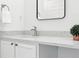 Modern bathroom with a sleek mirror and a stylish vanity with a quartz countertop at 5763 N Gibralter Way # 2-108, Aurora, CO 80019