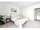 Bright bedroom featuring neutral colors, carpeted floors, and a comfortable bed with an ensuite at 5763 N Gibralter Way # 2-108, Aurora, CO 80019