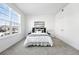 Bright bedroom featuring neutral colors, carpeted floors, a large window, and a comfortable bed at 5763 N Gibralter Way # 2-108, Aurora, CO 80019