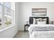 Bright bedroom featuring contemporary artwork and neutral colors with view to the exterior at 5763 N Gibralter Way # 2-108, Aurora, CO 80019