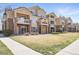 Attractive condo building featuring brick accents, private balconies, and well-maintained landscaping at 5763 N Gibralter Way # 2-108, Aurora, CO 80019