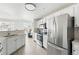 Bright kitchen with stainless appliances, breakfast bar, and eating area with modern light fixture at 5763 N Gibralter Way # 2-108, Aurora, CO 80019