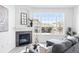 Cozy living room featuring a fireplace, large window, and comfortable seating area at 5763 N Gibralter Way # 2-108, Aurora, CO 80019