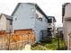 A quaint backyard featuring a trampoline, string lights and seating, perfect for outdoor enjoyment at 10025 E 63Rd Ave, Denver, CO 80238
