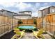 This backyard features a plunge pool, string lights, and comfortable yellow Adirondack chairs for relaxation at 10025 E 63Rd Ave, Denver, CO 80238