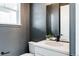 Modern powder room with a sleek vanity, black fixtures, and a neutral color palette at 10025 E 63Rd Ave, Denver, CO 80238