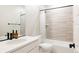 Modern bathroom with a sleek vanity, stylish faucet, and a combined tub and shower with tiled walls at 10025 E 63Rd Ave, Denver, CO 80238