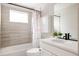 Chic bathroom featuring stylish tile work, modern fixtures, and a decorative shower curtain at 10025 E 63Rd Ave, Denver, CO 80238