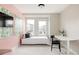Well-lit bedroom with a large window, modern desk area, and a comfortable bed at 10025 E 63Rd Ave, Denver, CO 80238