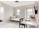 Bright bedroom with a cozy pink bed, stylish desk, and multiple windows providing ample natural light at 10025 E 63Rd Ave, Denver, CO 80238