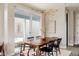 Bright dining area with a modern chandelier, stylish table and chairs, and sliding glass doors to outdoor space at 10025 E 63Rd Ave, Denver, CO 80238