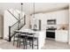 Modern kitchen featuring a sleek center island, stainless steel appliances, and contemporary design elements at 10025 E 63Rd Ave, Denver, CO 80238