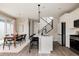 Modern open-concept kitchen featuring a white center island, stainless steel appliances, and a dining area at 10025 E 63Rd Ave, Denver, CO 80238
