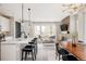 Bright, open-concept living room with modern lighting, sleek furnishings, and a contemporary fireplace feature at 10025 E 63Rd Ave, Denver, CO 80238