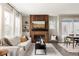 Bright living room with a striking wood accent wall, modern fireplace, and plenty of natural light at 10025 E 63Rd Ave, Denver, CO 80238