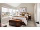 Comfortable main bedroom with a cozy bed, stylish decor, and a large window offering neighborhood views at 10025 E 63Rd Ave, Denver, CO 80238