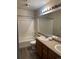 Full bathroom with a shower-tub combo and a vanity with double sinks and a large mirror at 20861 E 40Th Ave, Denver, CO 80249