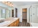 Bathroom featuring double sinks, a large mirror, and a shower enclosure at 20861 E 40Th Ave, Denver, CO 80249