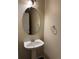 Neat half-bathroom featuring a pedestal sink, neutral wall paint, and chrome fixtures at 20861 E 40Th Ave, Denver, CO 80249