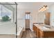 Bathroom with double vanity, large mirror, and separate shower and tub at 20861 E 40Th Ave, Denver, CO 80249
