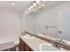 Bright bathroom featuring double sinks, a large mirror, and a shower-tub combination at 20861 E 40Th Ave, Denver, CO 80249