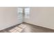 Light-filled bedroom with hardwood floors and a view to the outdoors at 20861 E 40Th Ave, Denver, CO 80249