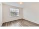 Light-filled bedroom with hardwood floors and a large window at 20861 E 40Th Ave, Denver, CO 80249