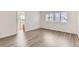 Bedroom featuring wood-style flooring, natural light from windows, and neutral paint at 20861 E 40Th Ave, Denver, CO 80249