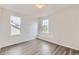 Bedroom featuring two windows providing ample natural light and wood-style flooring at 20861 E 40Th Ave, Denver, CO 80249