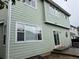 View of home exterior showing siding, sliding glass door, and patio at 20861 E 40Th Ave, Denver, CO 80249