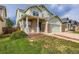 Charming two-story home featuring a brick-accented front porch and attached two-car garage with driveway at 20861 E 40Th Ave, Denver, CO 80249