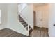 Hallway featuring stairs with white railing and wood-style flooring at 20861 E 40Th Ave, Denver, CO 80249