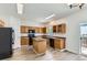 Well-lit kitchen with an island, black appliances, oak cabinets, and sleek flooring for modern living at 20861 E 40Th Ave, Denver, CO 80249