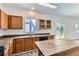 The kitchen features a wooden island, stainless steel sink, dark countertops, and oak-colored cabinets at 20861 E 40Th Ave, Denver, CO 80249