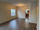Well-lit living room with hardwood floors, chandelier, and open access to the kitchen at 20861 E 40Th Ave, Denver, CO 80249
